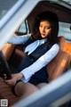 A woman sitting in the driver's seat of a car.